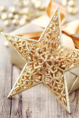 Shiny golden Christmas star and a gift