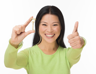 Asian woman hold old key isolated on white
