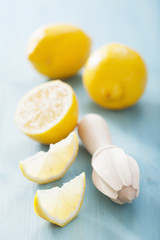 lemon and squeezer over blue background