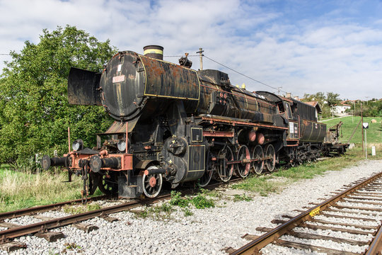 Ancient train with a steam locomotive on rails