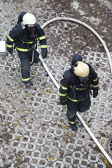 Two firefighters rush to rescue injured people