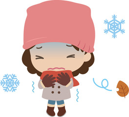 寒さで震えるコート姿の女性