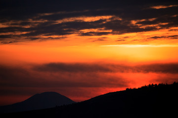 dramatic red sunset over the mountain ridge 