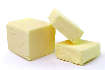 Stick of butter, cut, isolated on white.