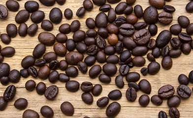 Fresh coffee beans on wood, ready to brew delicious coffee
