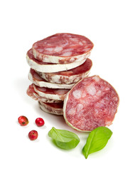 stacked sliced salami isolated on white