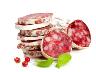 stacked sliced salami isolated on white
