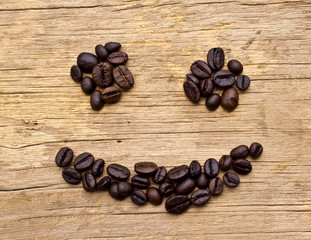 Smiling Coffee Beans on wood background