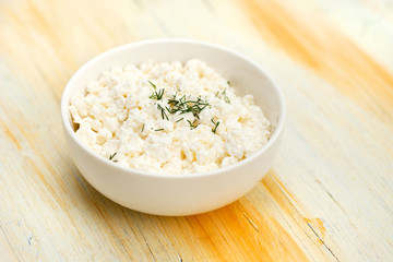 Healthy breakfast. Bowl of curd on vintage wooden table 