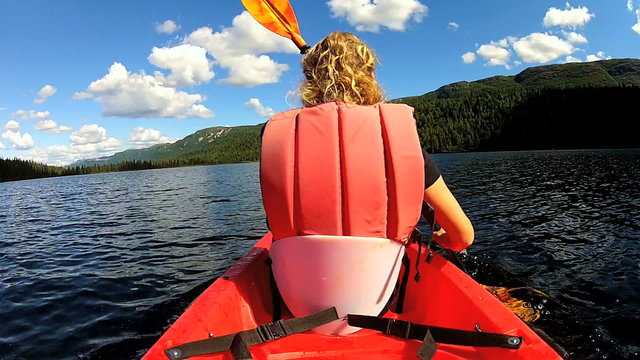 Young female kayaking, USA