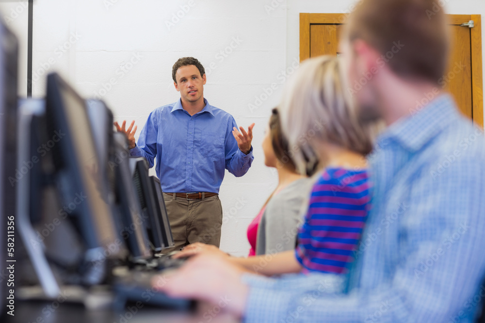 Poster teacher explaining to students in computer room