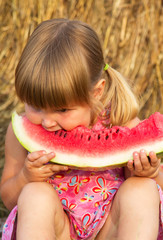 Portrait of the child who eats sweet water-melon