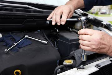 Fototapeta premium Hands of auto mechanic with wrench.