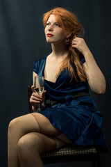 beautiful red-haired girl in a blue dress.