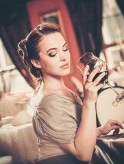 Beautiful young girl  alone in a restaurant