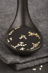 Ceramic spoon with soy sauce, close-up with selected DOF © longtaildog