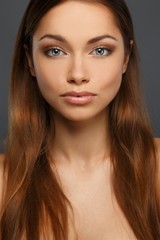 Obraz premium Beautiful young brunette woman with blue eyes