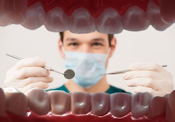 View at young male dentist  from patient mouth