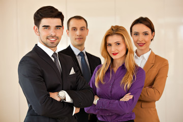 business people smiling  with arms crossed