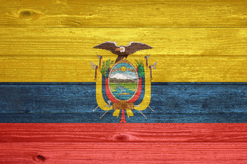 Ecuador Flag painted on old wood plank background.