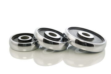 three dumb-bell weights isolated in white