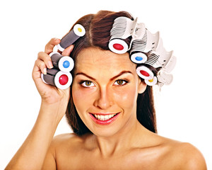 Woman wear hair curlers on head.