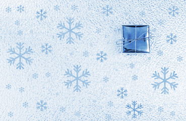 Christmas present over cold blue background