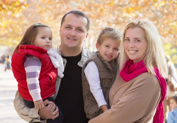 Family with two children in autumn park