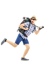 Scared hiker with backpack and camera running away