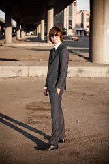 portrait of young businessman in sunglasses standing on street