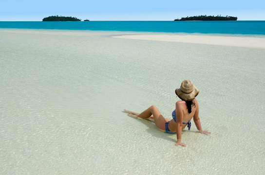Young woman relaxing on Aitutaki Lagoon Cook Islands