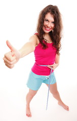 sporty fit woman with measure tape thumbs up