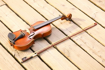 Violin on wooden pier. Music concept