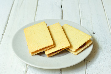 Crackers crispy cheese stuffed with pineapple on wood-table.