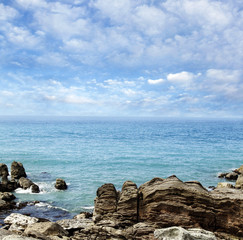 Shoreline rocks, sea and sky