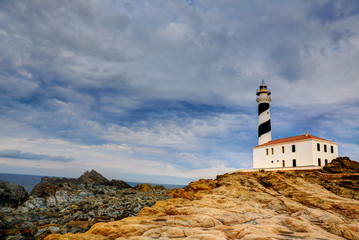 Fototapeta na wymiar Cap de Favaritx sunset lighthouse cape in Mahon