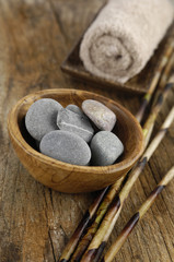 zen stones and towel in bowl and dry thin bamboo grove