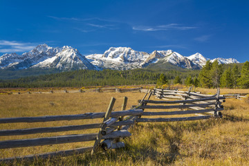 Idaho mountain range and log fence with snow