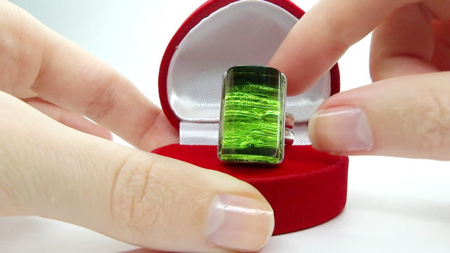 Jewelery emerald ring in red box as present
