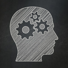 Advertising concept: Head With Gears on chalkboard background