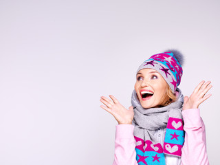happy surprised woman in winter clothes with positive emotions