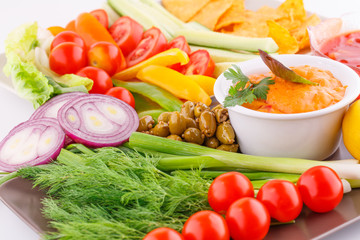 Vegetables, olives, nachos, red and cheese sause