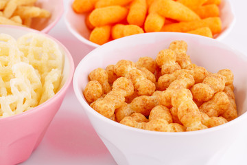 Potato, corn and wheat chips in bowls