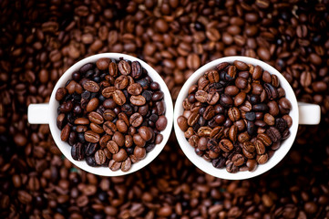 Detail of white cups of coffee filled with coffee beans