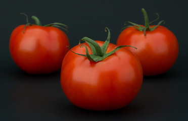 Tomato vegetables isolated on black background