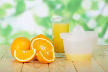 Orange slices, glass and juice extractor