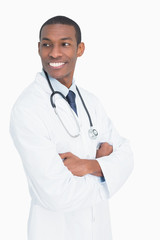 Fototapeta premium Smiling male doctor standing with arms crossed