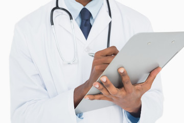 Mid section of a male doctor writing on clipboard