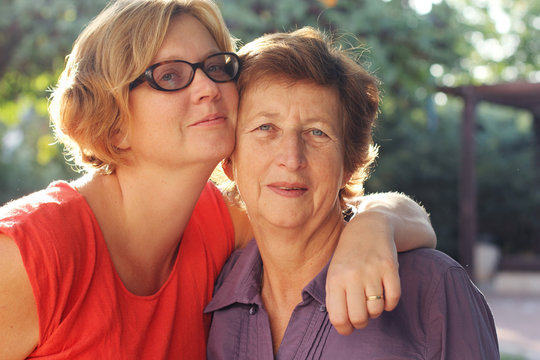 Portrait of beautiful senior woman and her adult daughter