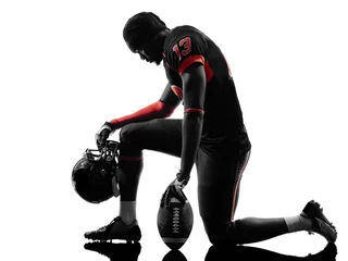 Fotobehang american football player kneeling silhouette © snaptitude